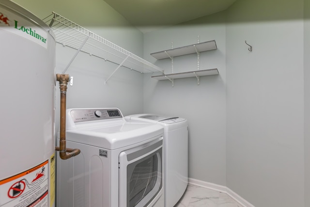 laundry room featuring washer and dryer, water heater, laundry area, and marble finish floor
