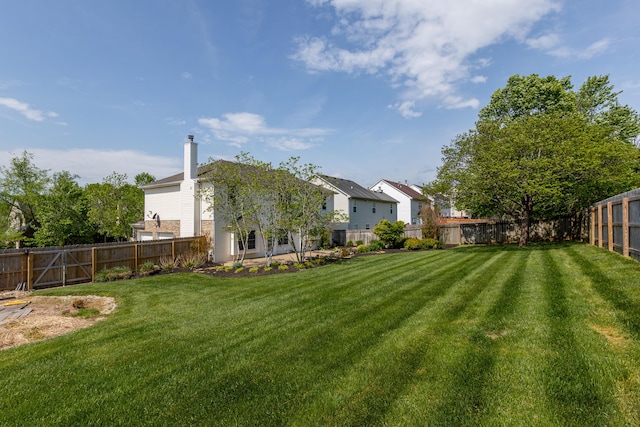 view of yard featuring a residential view and a fenced backyard