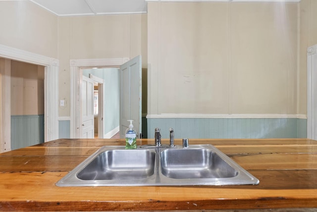 details featuring a sink and wood counters