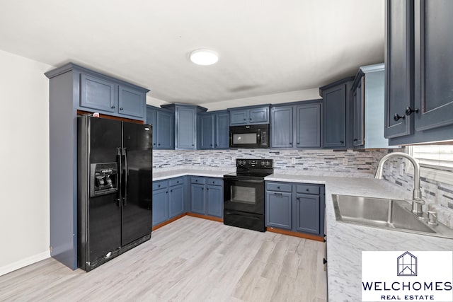 1008 Alexandria Dr, Lawrenceburg, KY 40342 - kitchen featuring a sink, blue cabinetry, backsplash, black appliances, and light wood-type flooring