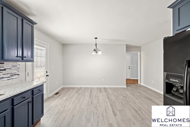1008 Alexandria Dr, Lawrenceburg, KY 40342 - kitchen featuring light wood-style floors, baseboards, black fridge with ice dispenser, and decorative light fixtures