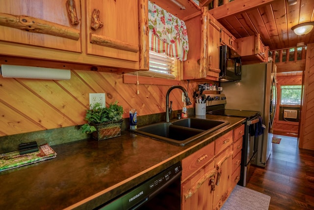 kitchen featuring black microwave, dark countertops, wooden walls, stainless steel electric stove, and a sink
