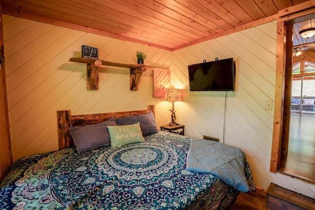 bedroom featuring wooden walls, wooden ceiling, and wood finished floors
