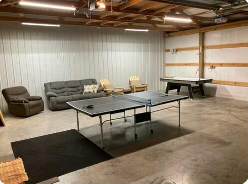 rec room featuring a garage and finished concrete floors