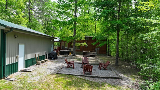 view of yard with an outdoor fire pit and a patio area