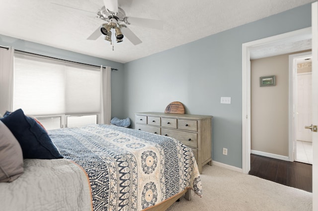 carpeted bedroom featuring baseboards and ceiling fan