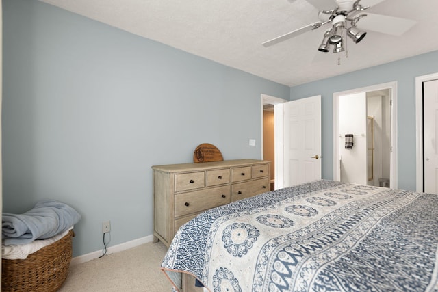 bedroom featuring baseboards, light carpet, and a ceiling fan
