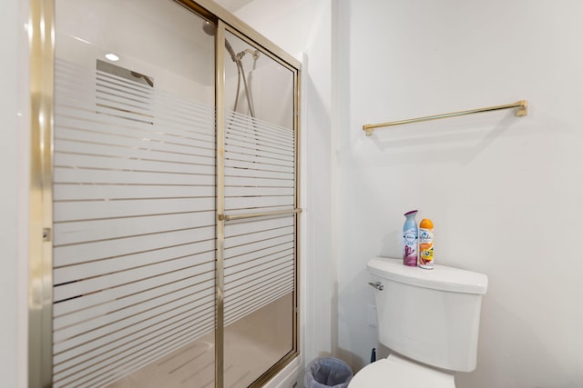full bathroom featuring a stall shower and toilet