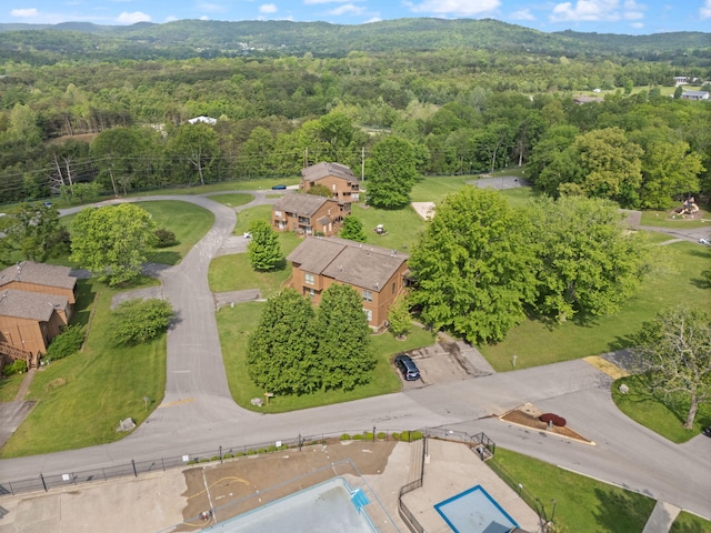 drone / aerial view with a wooded view