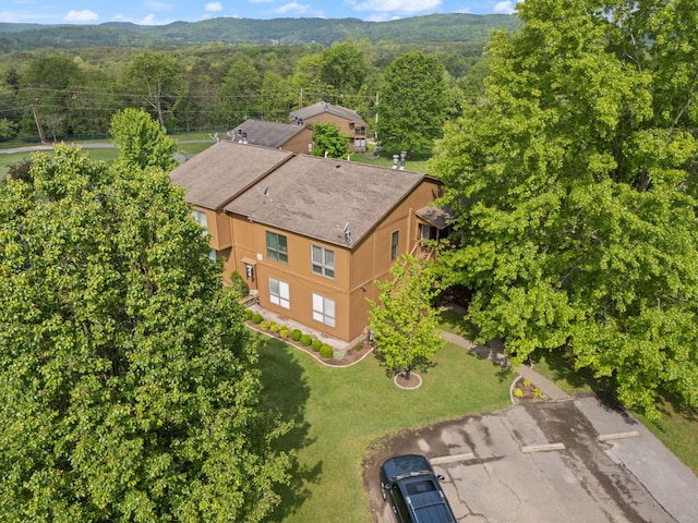 birds eye view of property featuring a view of trees