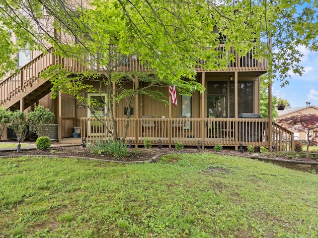 back of property featuring a yard