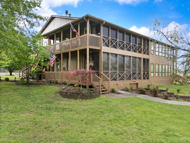 rear view of house with a sunroom, a yard, and crawl space