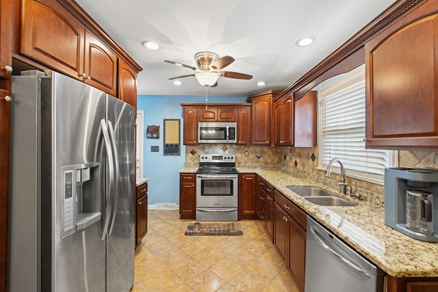 107 Highview Dr, Midway, KY 40347 - kitchen featuring appliances with stainless steel finishes, light stone counters, a sink, a ceiling fan, and decorative backsplash