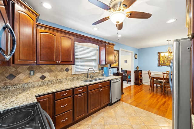 107 Highview Dr, Midway, KY 40347 - kitchen with a ceiling fan, appliances with stainless steel finishes, tasteful backsplash, a sink, and light stone counters