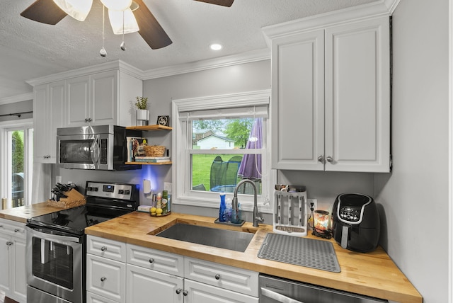 220 Garden Ave, Stanford, KY 40484 - kitchen featuring a sink, wooden counters, white cabinets, a ceiling fan, and appliances with stainless steel finishes
