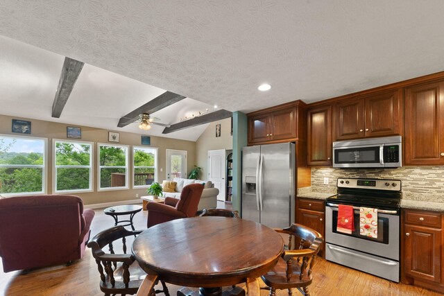 7314 Blue Level Rd, Rockfield, KY 42274 - kitchen with light wood-style floors, open floor plan, ceiling fan, tasteful backsplash, and appliances with stainless steel finishes