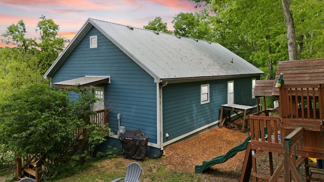 7314 Blue Level Rd, Rockfield, KY 42274 - back of property at dusk with metal roof and a playground