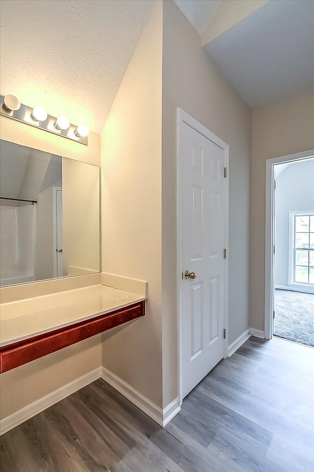 1148 Oatlands Park, Lexington, KY 40509 - bathroom featuring baseboards, wood finished floors, and lofted ceiling