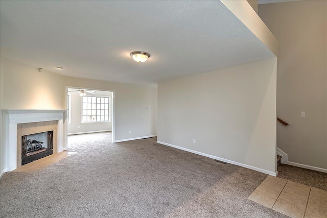 1148 Oatlands Park, Lexington, KY 40509 - unfurnished living room featuring a ceiling fan, a tile fireplace, stairway, baseboards, and carpet
