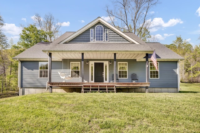 back of house featuring roof with shingles, a yard, and a porch