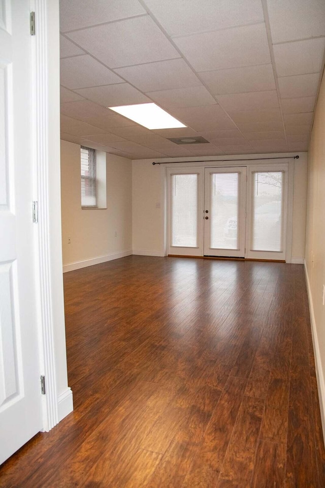 unfurnished room with baseboards and wood finished floors