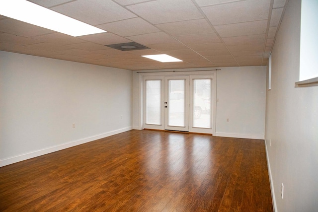 unfurnished room featuring baseboards and wood finished floors