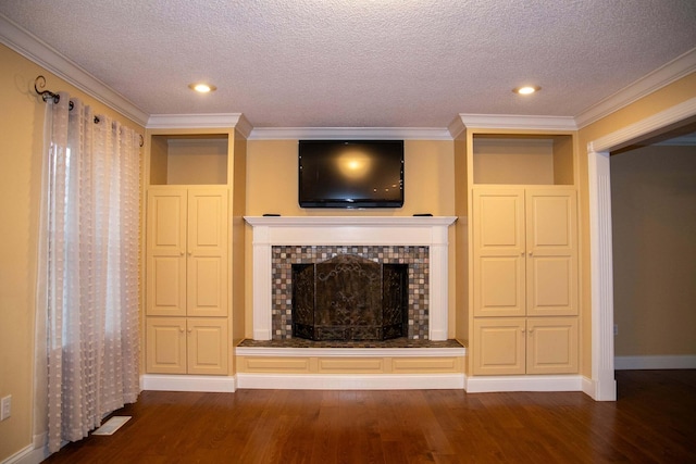unfurnished living room with a brick fireplace, a textured ceiling, crown molding, and wood finished floors