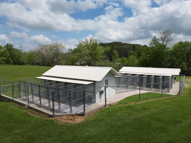 exterior space with a pole building, an exterior structure, and an outbuilding
