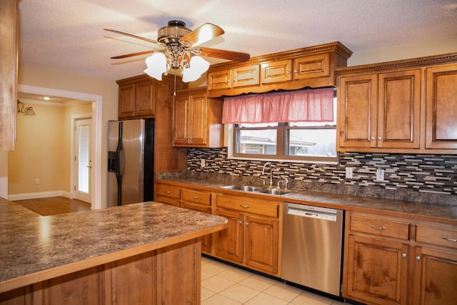 kitchen with a sink, stainless steel appliances, and brown cabinets