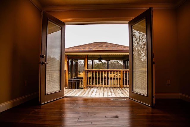interior space featuring baseboards, ornamental molding, hardwood / wood-style flooring, and visible vents