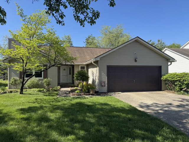 single story home featuring a garage, roof with shingles, concrete driveway, and a front lawn