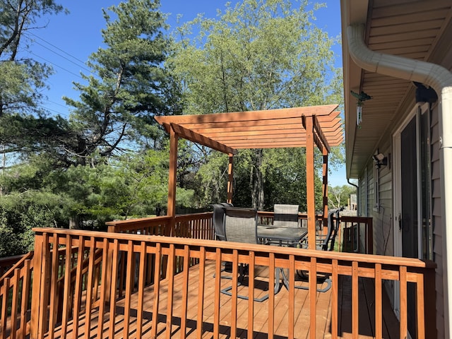 deck featuring a pergola and outdoor dining area