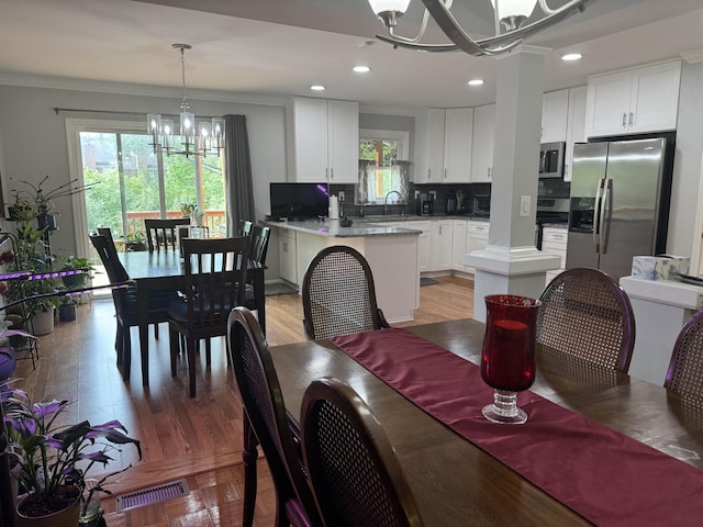 dining room featuring visible vents, ornamental molding, recessed lighting, and a notable chandelier