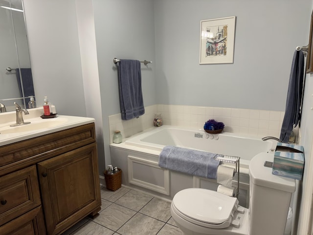 bathroom with toilet, tile patterned floors, a garden tub, and vanity
