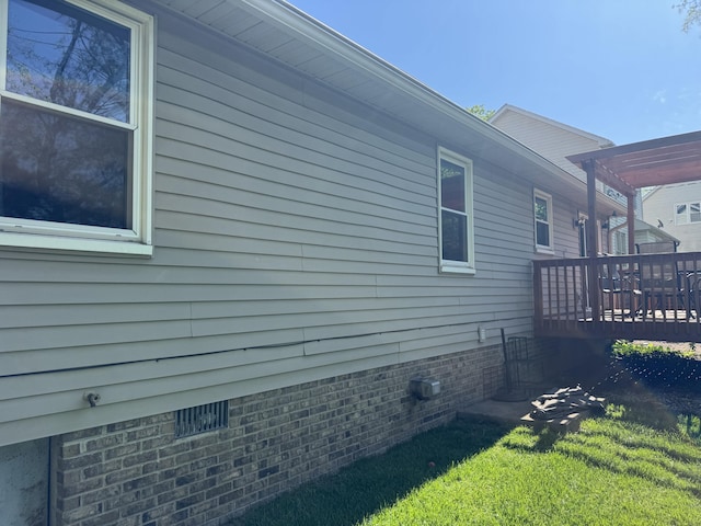 view of side of property with a yard, a pergola, and a deck