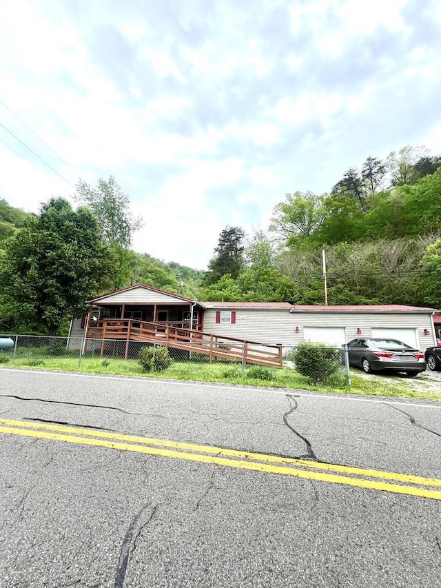 view of front of property with a garage and fence