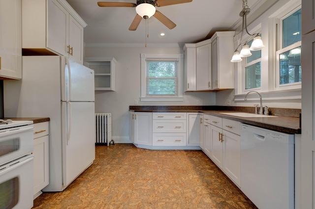 kitchen featuring ceiling fan, dark countertops, a sink, white appliances, and radiator heating unit