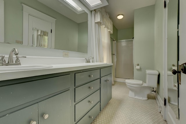 full bath with a sink, walk in shower, toilet, and double vanity