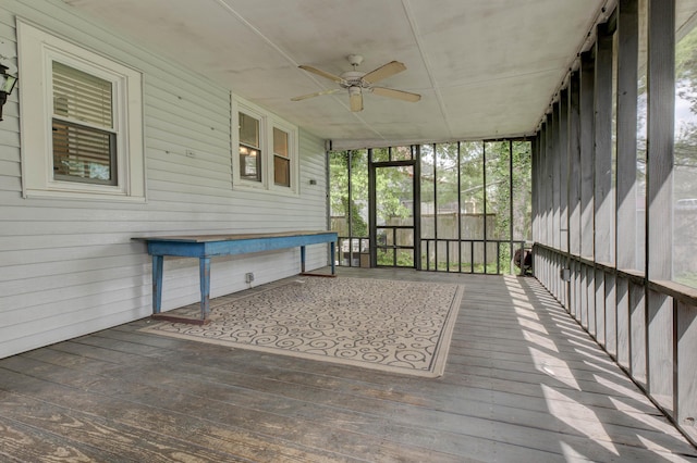 unfurnished sunroom with a ceiling fan