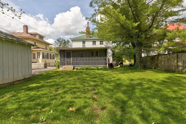 view of yard with fence and a sunroom