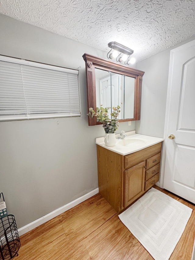 187 Sinnette, Greenup, KY 41144 - bathroom featuring vanity, baseboards, and wood finished floors