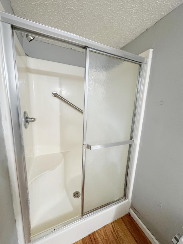 187 Sinnette, Greenup, KY 41144 - full bath with a textured ceiling, wood finished floors, and a shower stall