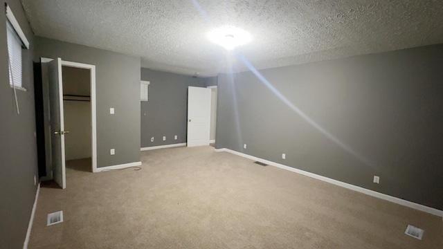 187 Sinnette, Greenup, KY 41144 - unfurnished bedroom featuring carpet flooring, a textured ceiling, baseboards, visible vents, and a closet