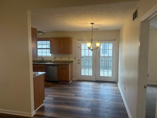 kitchen featuring an inviting chandelier, baseboards, stainless steel dishwasher, visible vents, and dark wood-style floors