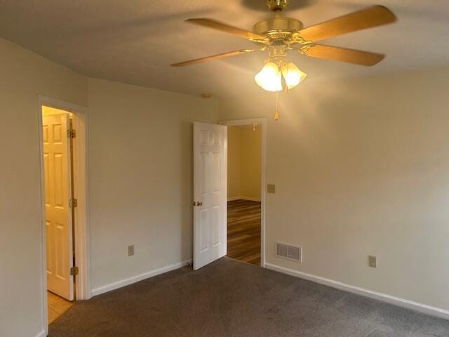 unfurnished bedroom featuring visible vents, carpet, and baseboards