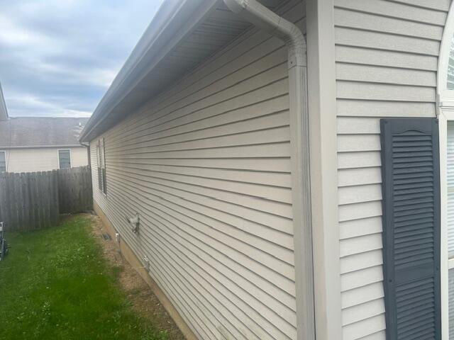 view of home's exterior featuring fence