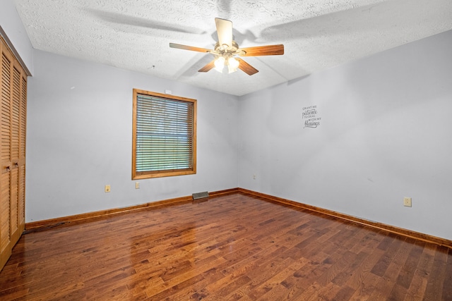 140 Adams Ln, Richmond, KY 40475 - unfurnished bedroom with wood finished floors, a closet, a textured ceiling, baseboards, and ceiling fan