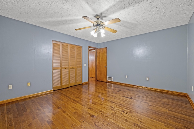 140 Adams Ln, Richmond, KY 40475 - unfurnished bedroom featuring baseboards, wood-type flooring, a textured ceiling, a closet, and ceiling fan