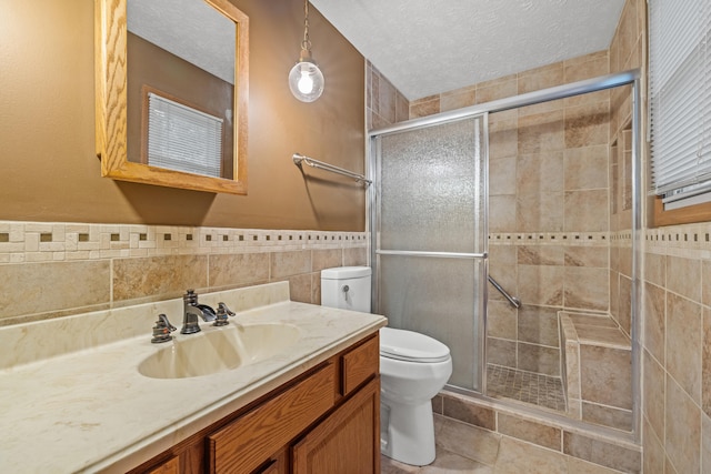 140 Adams Ln, Richmond, KY 40475 - bathroom featuring a shower stall, toilet, tile walls, vanity, and a textured ceiling
