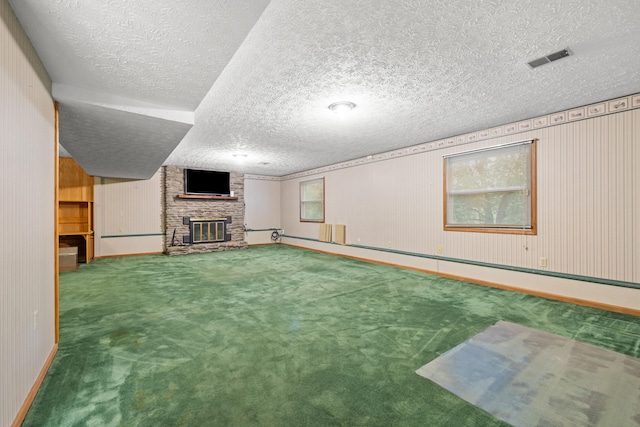 140 Adams Ln, Richmond, KY 40475 - basement featuring a large fireplace, a textured ceiling, carpet floors, baseboards, and wooden walls